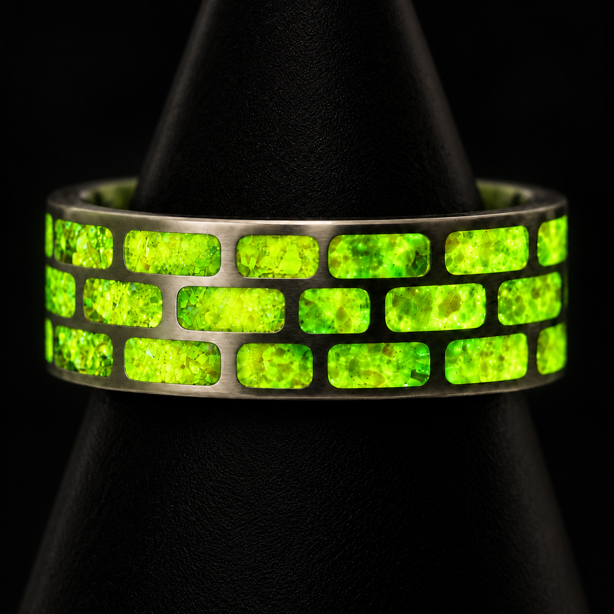 Yellow Brick Road titanium ring glowing vivid yellow green in darkness